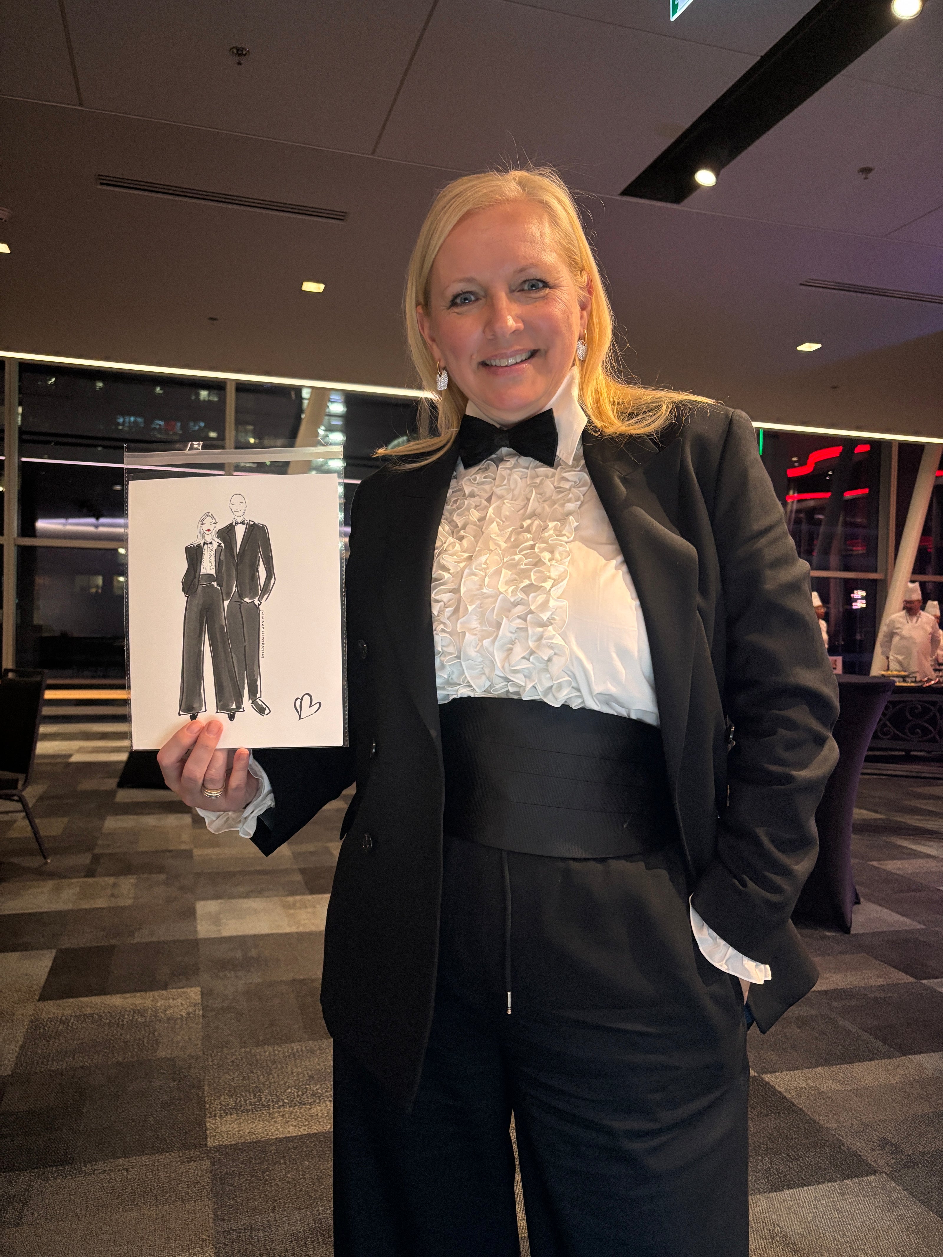 Person holding a black and white illustration by Nina Maric