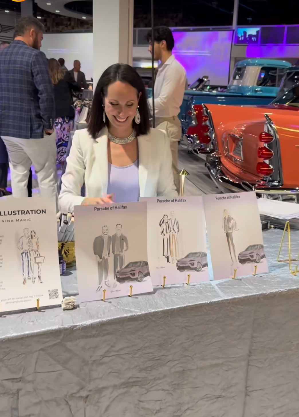 Nina Maric at a table with live illustrations in a car showroom setting