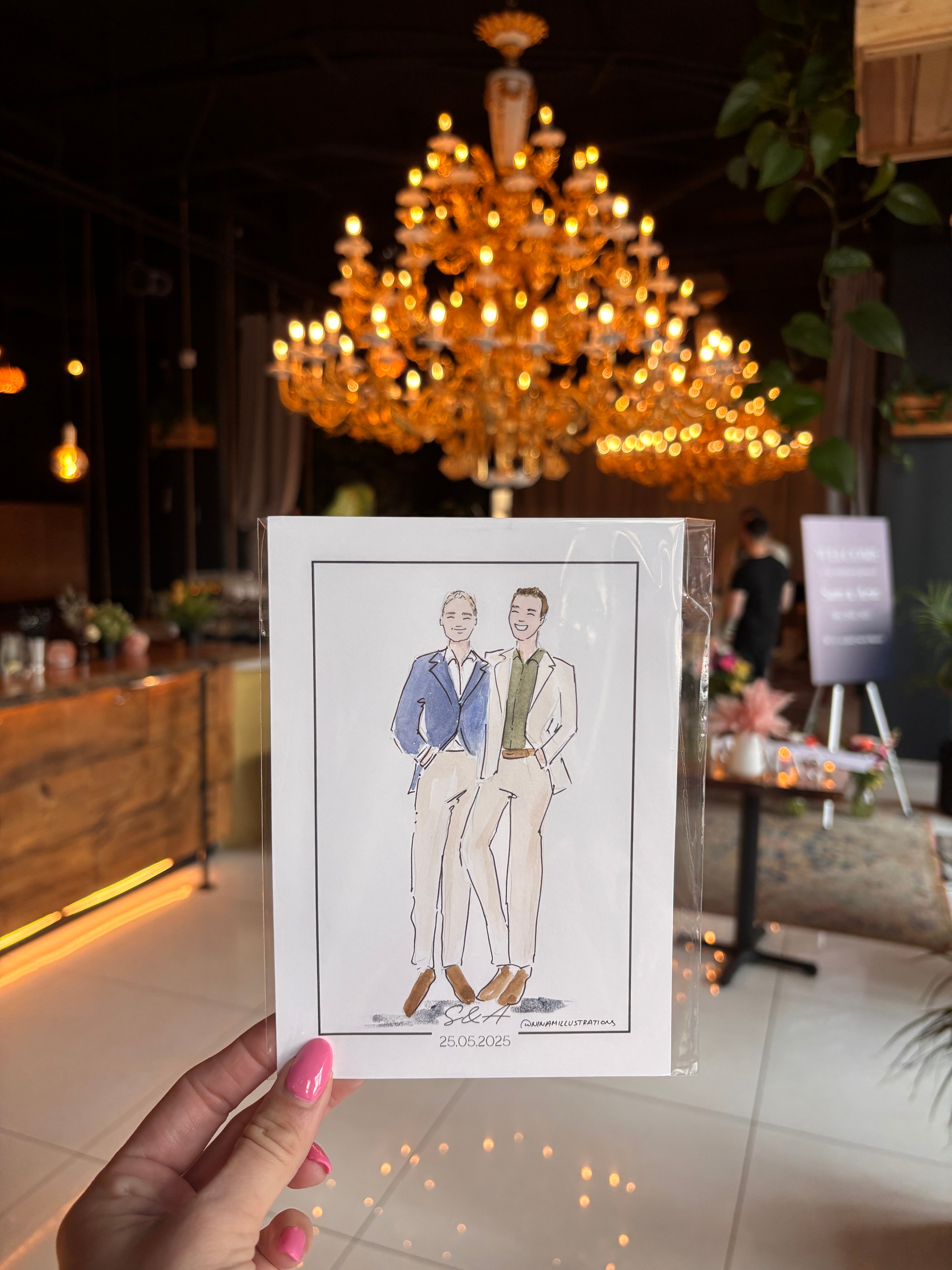 Hand holding a card with illustrations of two men in formal attire against a blurred indoor background.