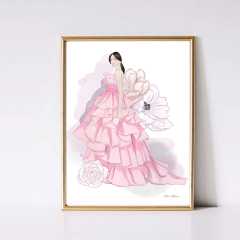 A beautiful portrait of a woman in a long pink ruffle gown surrounded by vibrant dahlias in the background, all captured in stunning watercolor. Perfectly framed, this piece adds a touch of elegance and femininity to any space. Hand illustrated and painted by Nina Maric artist.